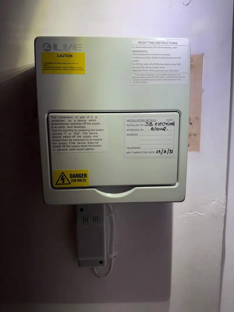 A certified consumer unit with the next inspection date written on the door