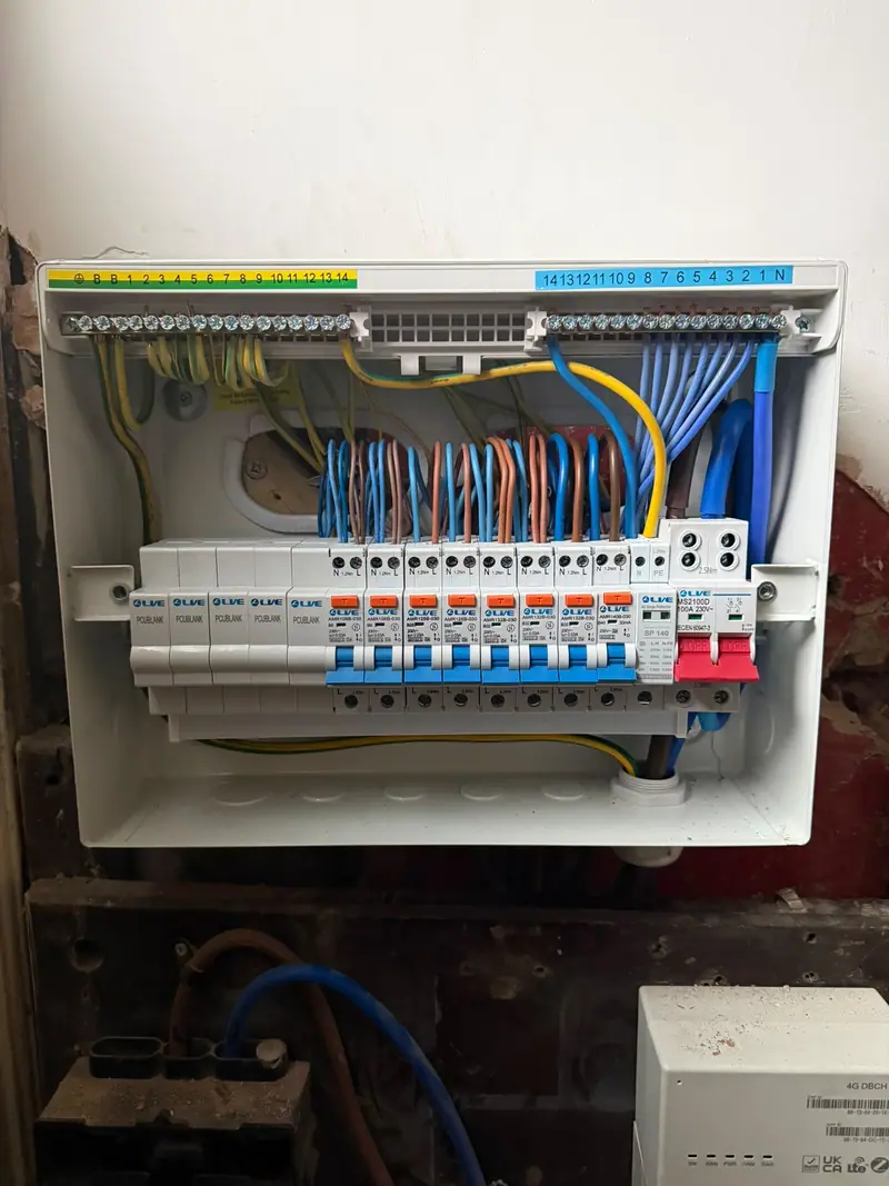 A newly fitted fourteen-way consumer unit with an RCBO on every circuit, every conductor dressed neatly to the bars